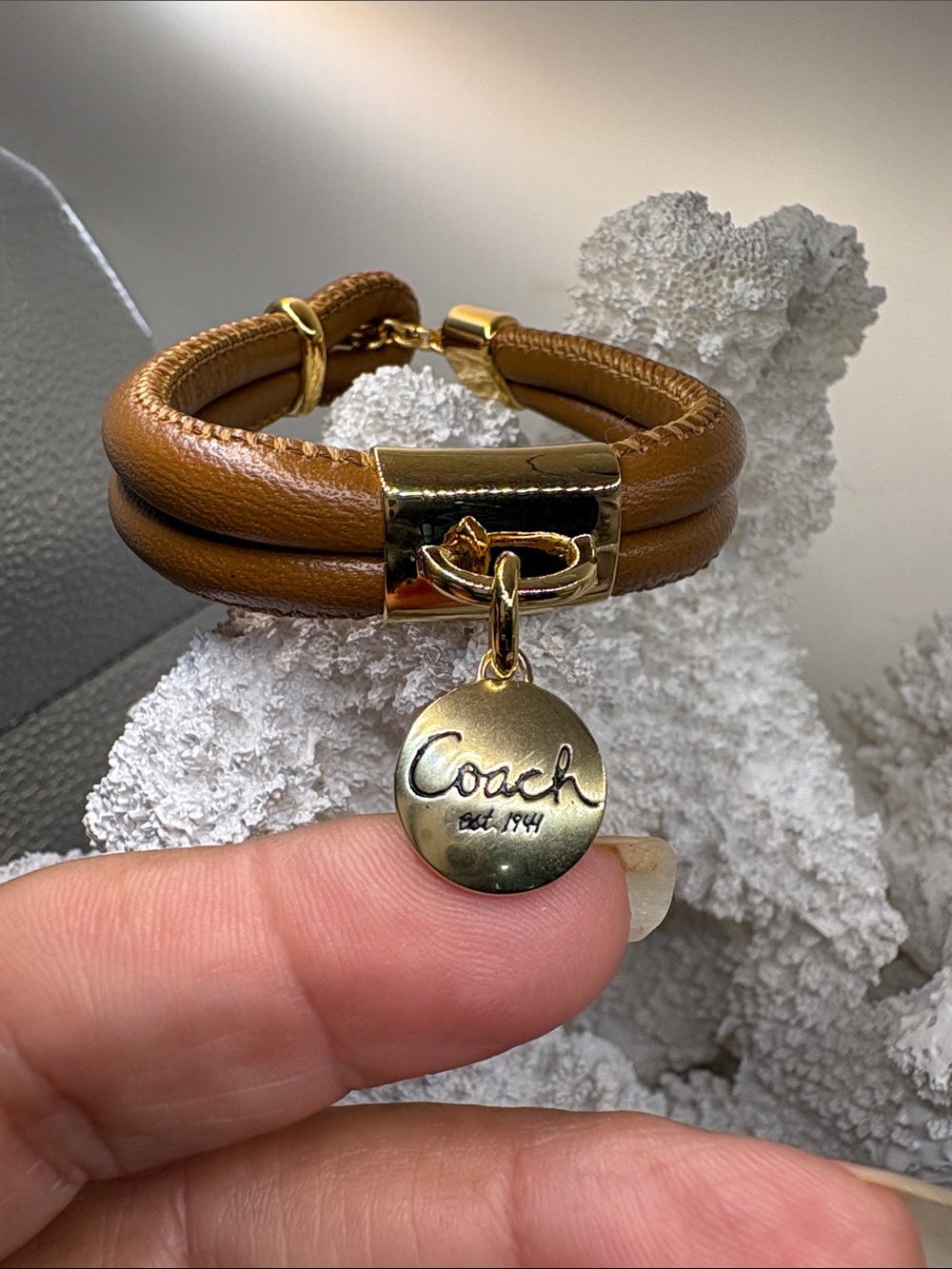 Coach Disc Charm on a Tan Double-Wrap Bracelet
